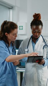 doctor-nurse-working-with-tablet-healthcare-system-cabinet-medical-team-medic-assistant-using-technology-examination-treatment-specialists-doctors-office-they-need-nursing-assignment-help